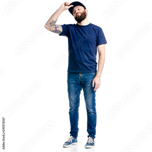 A man in jeans and cap standing looking up on a white background. Isolation