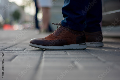 feet in shoes of people walking on the street © Arlington Vance