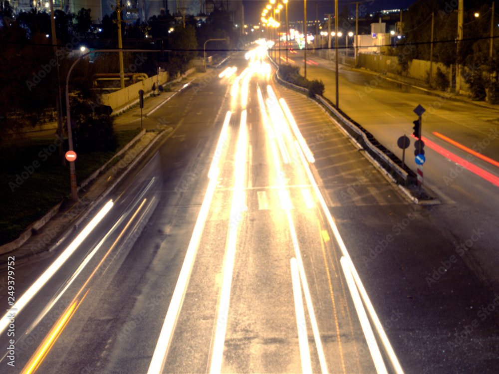 Blurred motion of cars at night, highway forming white lights