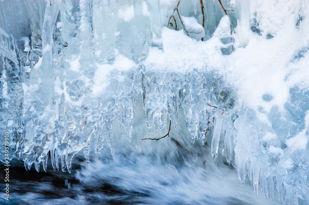 Beautiful mountain river in winter  with icicles