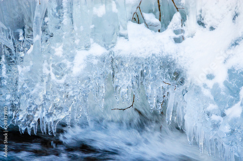 Beautiful mountain river in winter  with icicles © Olena Zn