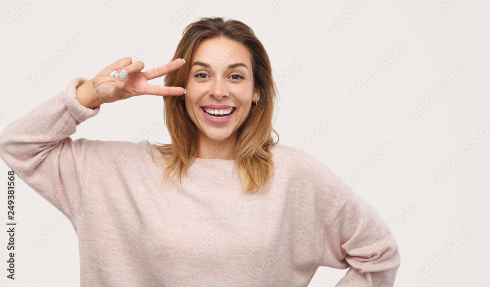 Excited female gesturing V sign