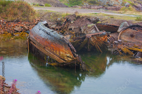 old wooden boat over the river, остатки разрушенной лодки на берегу Баренцево моря Териберка кладбище кораблей Кольский Мурманская область