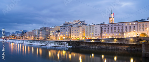Panoramic view to river side with buildings in winter twilight in Salzburg in Austria
