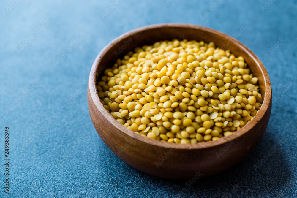 Yellow Lentils in Wooden Bowl.