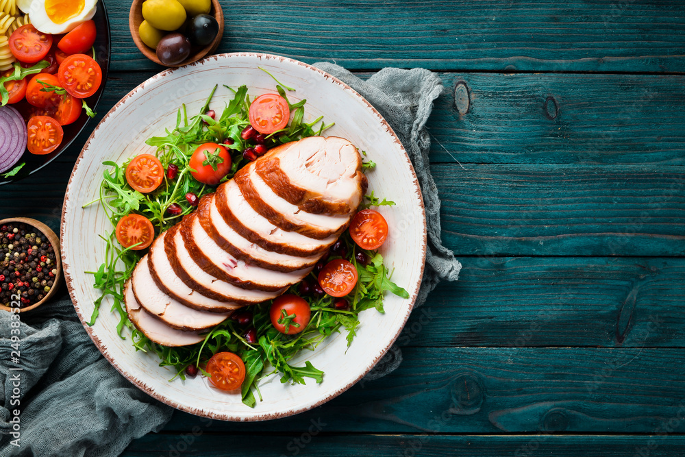 Smoked chicken fillet and salad. Top view. Free space for your text. Smoked chicken fillet and salad. Top view. Free space for your text.