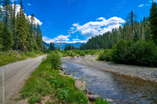 Gravel Road with Stream and Mountains