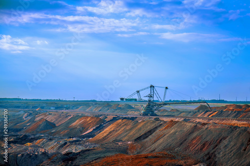 Industrial view of opencast mining quarry with machinery at work. Area has been mined for copper silver  gold  and other minerals