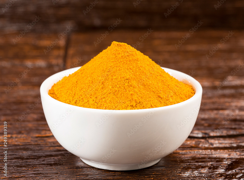 Turmeric spice used in alternative medicine - Curcuma longa. Wood background Turmeric spice used in alternative medicine - Curcuma longa. Wood background