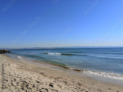 a perfectly flat horizon of the calm sea without waves and clear skies  the background of natural tranquillity.  summer trip