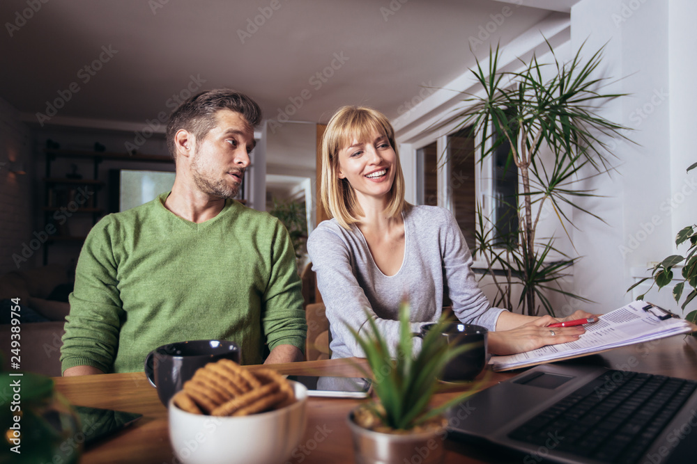 Happy couple with laptop spending time together at home Happy couple with laptop spending time together at home