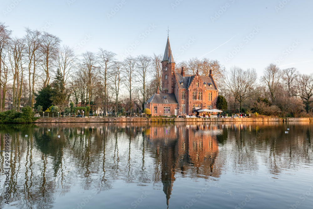 Minnewater Park (Lake of Love) winter panoramic view with Castle de la Faille, flemish style red brick building and its reflection in the water, Bruges, West Flanders, Belgium Minnewater Park (Lake of Love) winter panoramic view with Castle de la Faille, flemish style red brick building and its reflection in the water, Bruges, West Flanders, Belgium