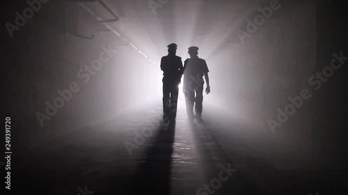 Two Indian Policemen comes towards camera, tunnel background