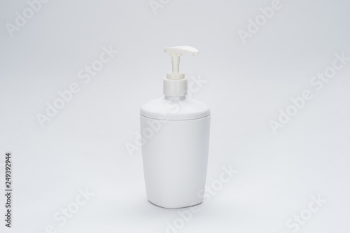 white soap dispenser on the grey background