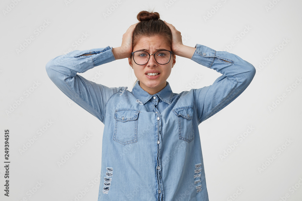 The girl clutched at her head in a panic in despair, doesnot know where to run or what to do. Oh my God, disaster, gritted her teeth isolated on a white background. The girl clutched at her head in a panic in despair, doesnot know where to run or what to do. Oh my God, disaster, gritted her teeth isolated on a white background.