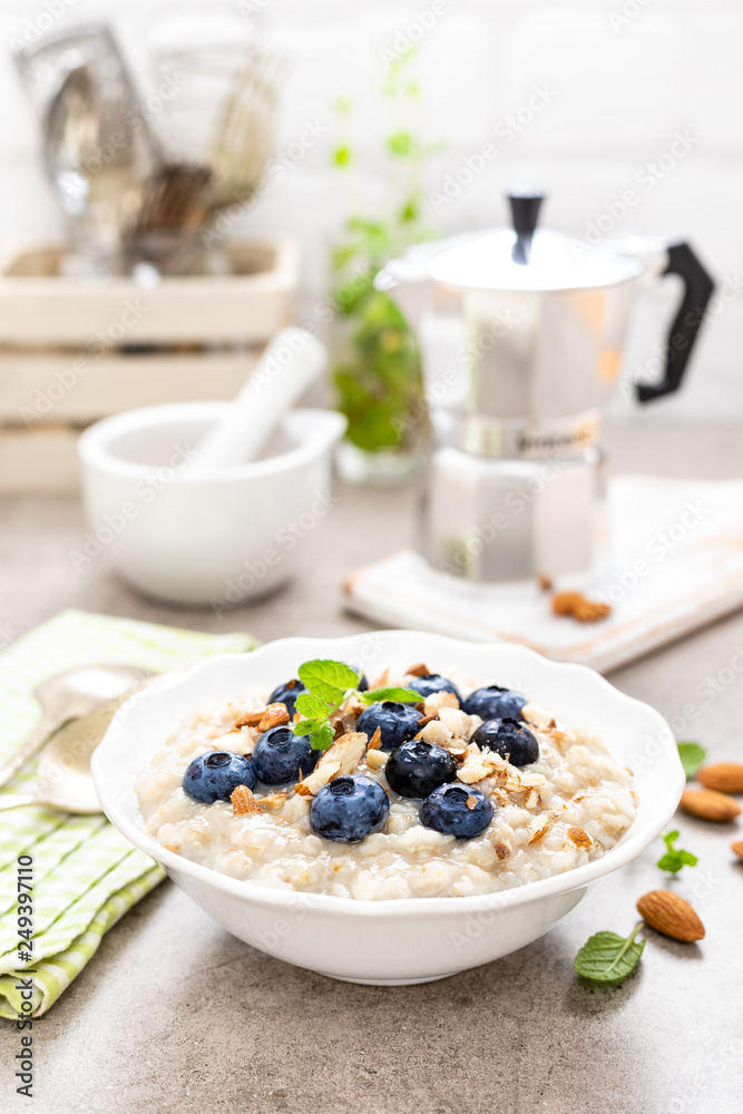 Oatmeal with fresh blueberry, almond nuts and honey for breakfast