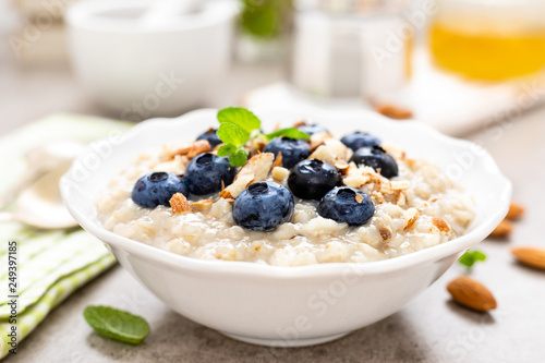 Oatmeal with fresh blueberry, almond nuts and honey for breakfast