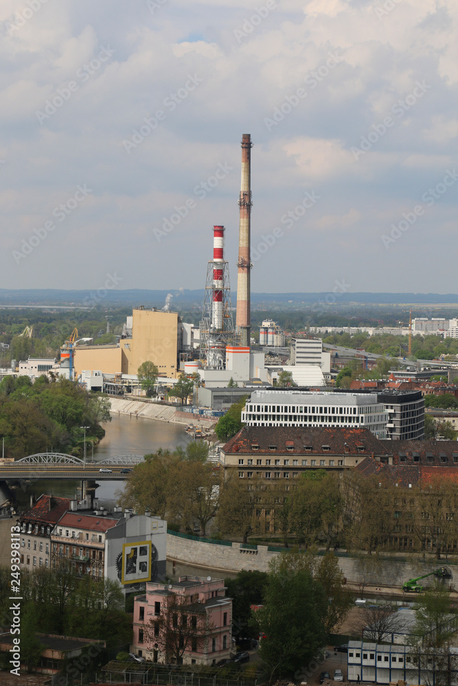 Obraz premium Spring day in Wroclaw. View from the tower of church of St. Elisabeth to the Nadodrze, outskirts. Visible buildings, tenements, bridge, Odra river, blocks of flats, heat and power station, chimneys.