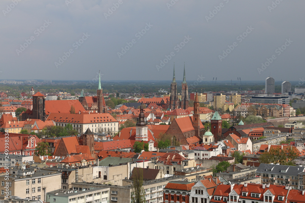 Obraz premium Warm, spring day in Wroclaw. View from the tower of the church of Saint Elizabeth to the Cathedral, Ostrów Tumski, old town, churches, Odra River, blocks of flats, the Olympic Stadium, dormitories