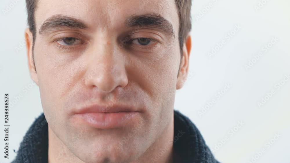 Close-up of Handsome guy looking at camera on white background. Portrait of young man. Close-up of Handsome guy looking at camera on white background. Portrait of young man.