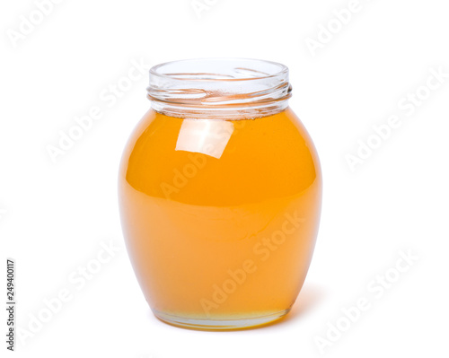 honey dipper and honey in jar on white background