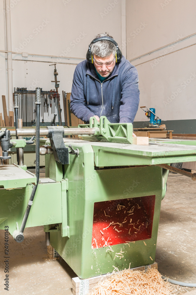 Male carpenter working in his carpentry workshop. Male carpenter working in his carpentry workshop.