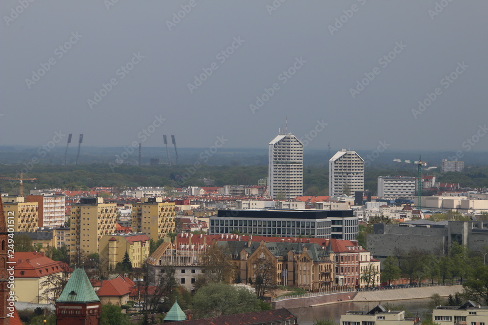 Obraz premium Warm, spring day in Wroclaw. View from the tower of the church of Saint Elizabeth to buildings, university, Odra river, blocks of flats, Olympic Stadium, dormitories. Wrocław, Breslau, Polen, Poland