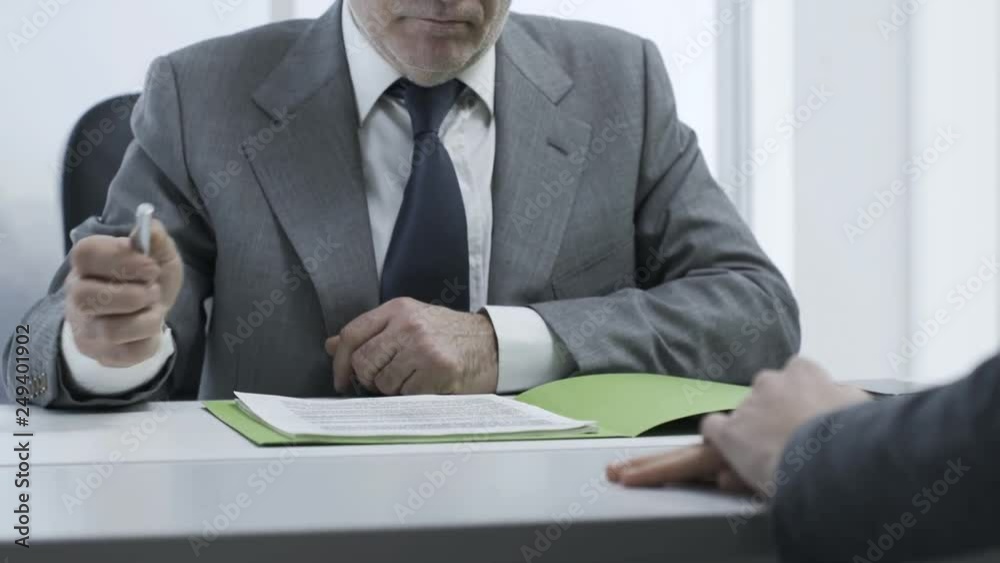 Employer checking the candidate's resume during a job interview Employer checking the candidate's resume during a job interview