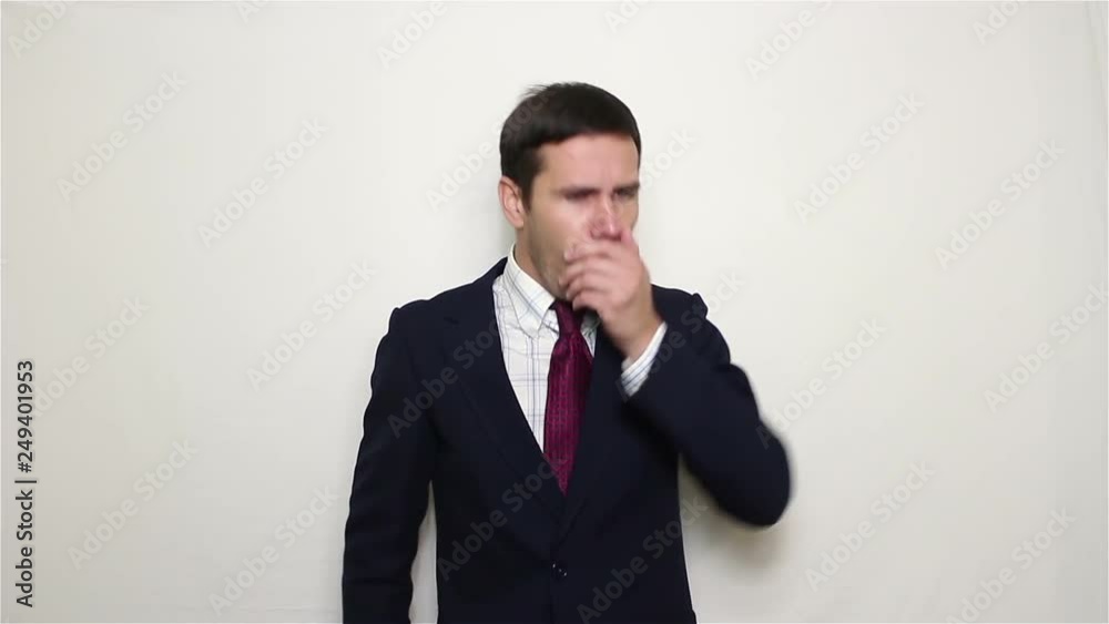 Young handsome businessman coughs and covers his mouth with his hand. Portrait on white background. Young handsome businessman coughs and covers his mouth with his hand. Portrait on white background.