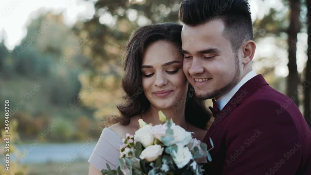 Portrait of happy wedding couple stands in embraces of each other Portrait of happy wedding couple stands in embraces of each other