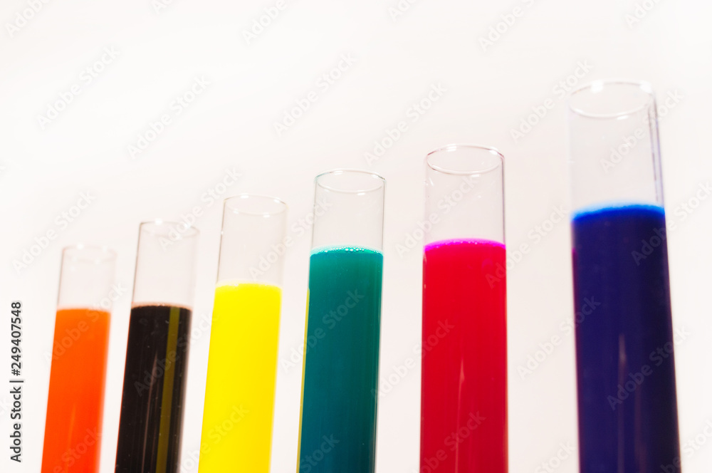 many test tubes filled with fluids of various colors many test tubes filled with fluids of various colors