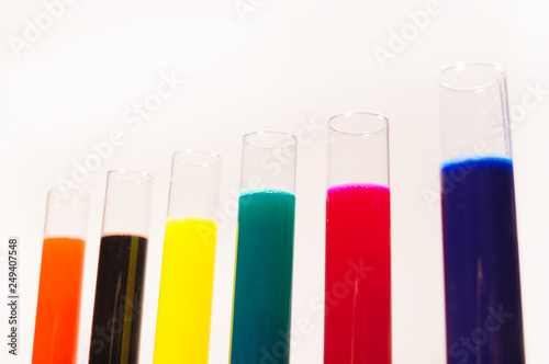 many test tubes filled with fluids of various colors