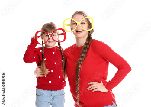 Happy woman and daughter with funny glasses on white background