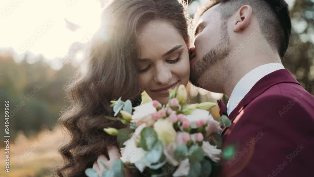 Close-up wedding couple, groom kisses his happy bride's neck Close-up wedding couple, groom kisses his happy bride's neck