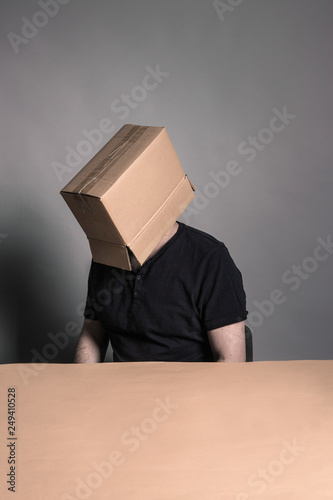 Man's face covered with cardboard box