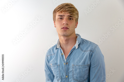 Pensive young man portrait in white background