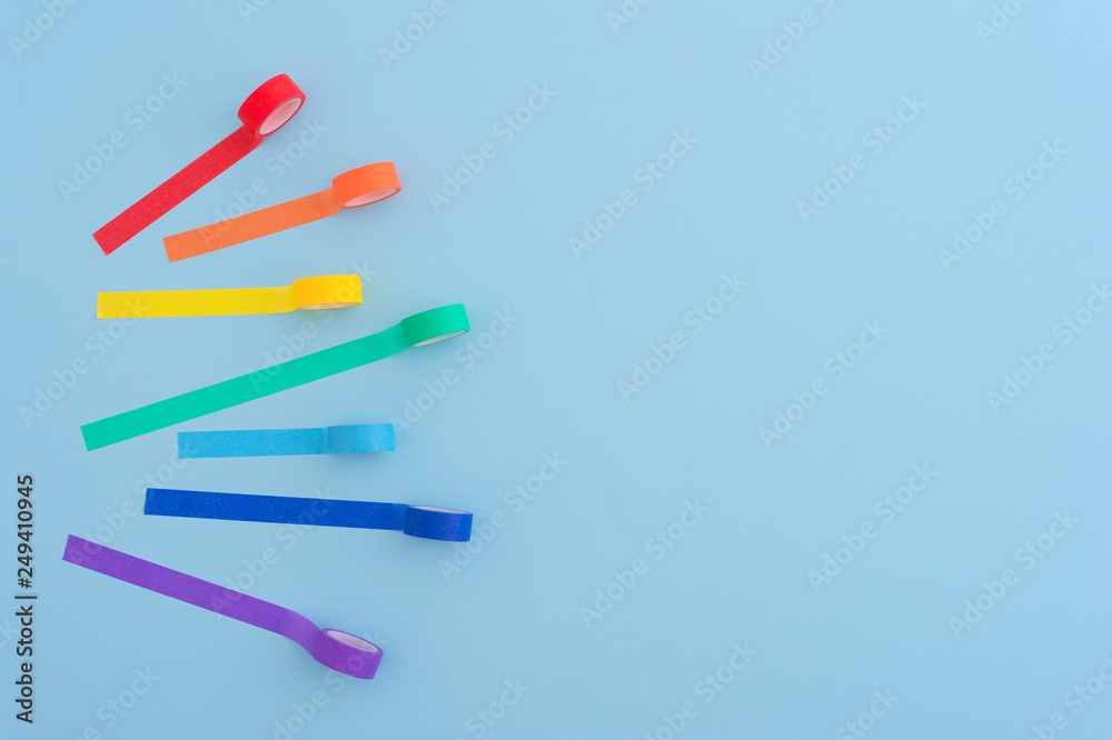 Colorful school tapes on a bright blue background.