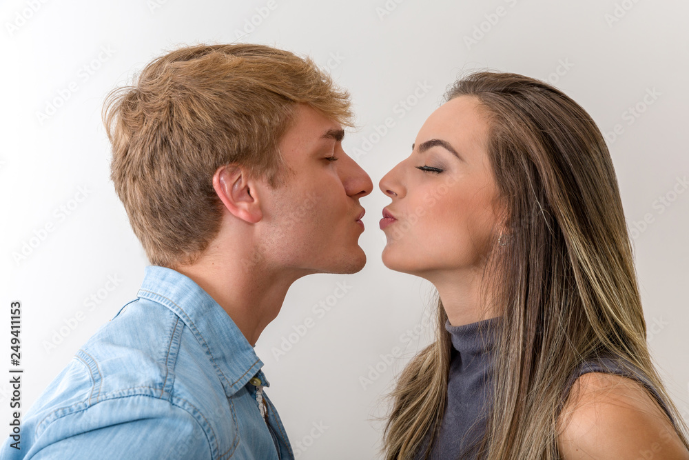 Side view of happy couple going to kiss on white background Side view of happy couple going to kiss on white background