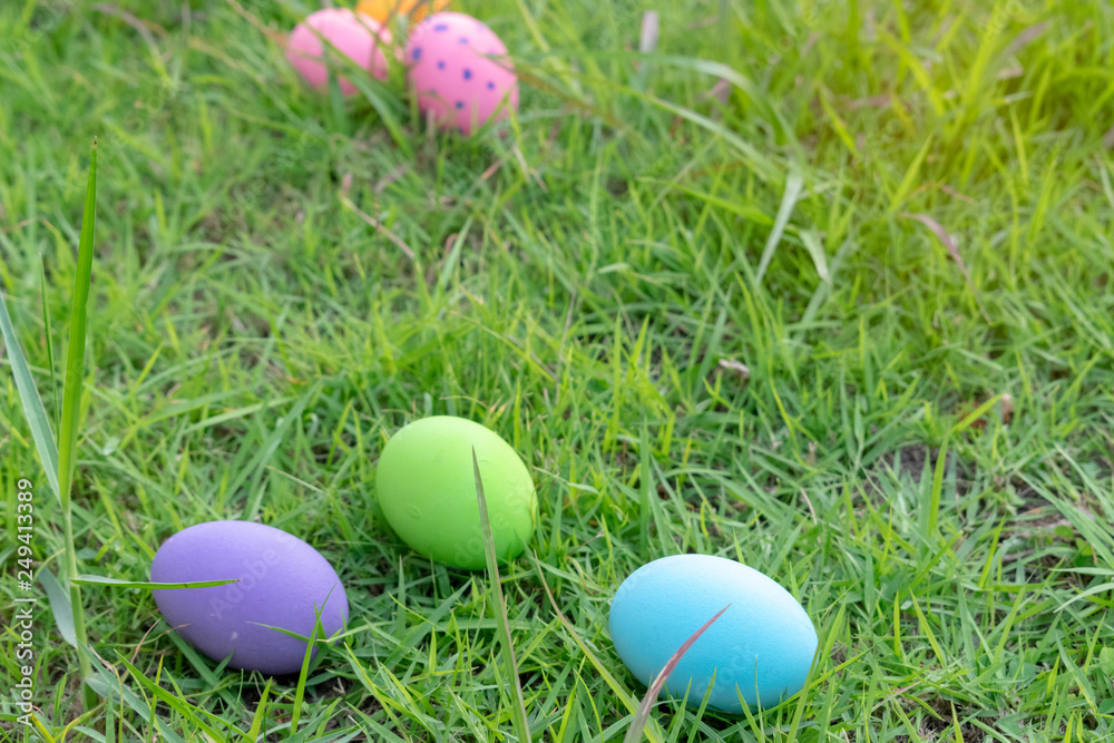 Happy Easter. Easter eggs concept. The colorful of Easter eggs in nest on grass green background. Happy Easter. Easter eggs concept. The colorful of Easter eggs in nest on grass green background.