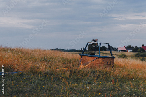 empty air balloon basket in the field after landing