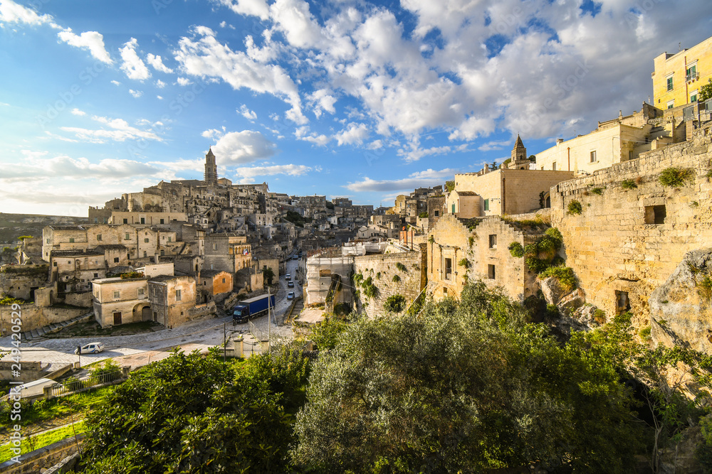 View from the convent of Saint Agostino a traffic drives down the main road through the ancient city of Matera, Italy.
