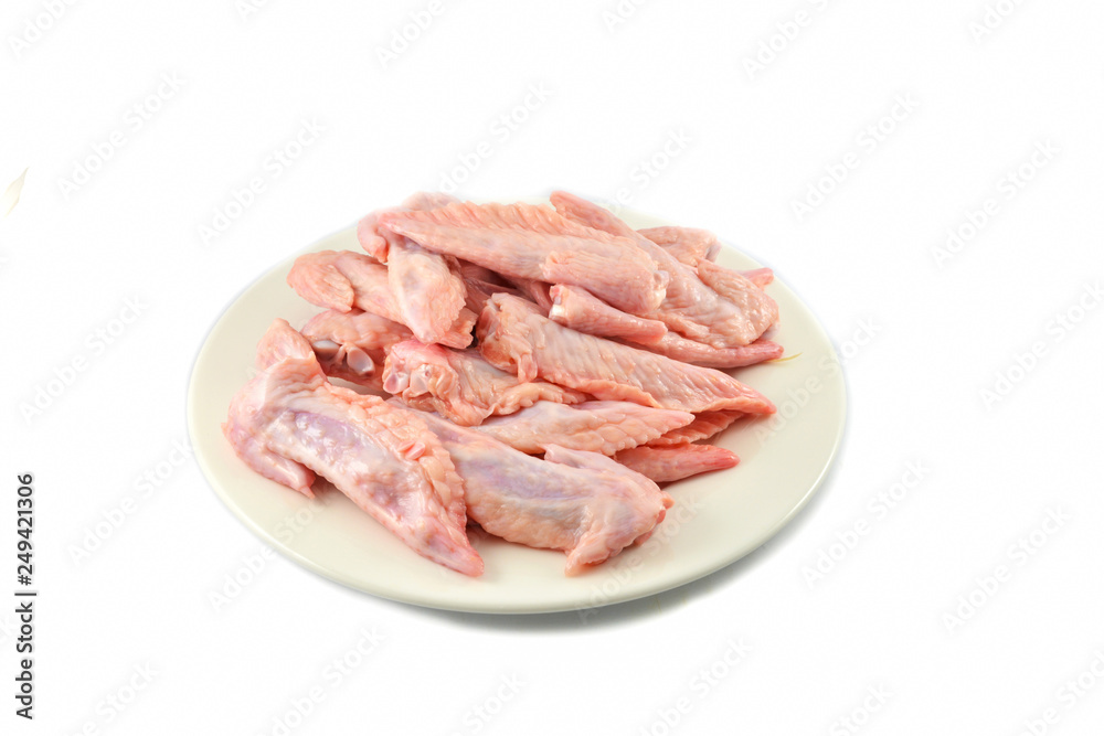 Fresh raw chicken wing on plate isolated on white background Fresh raw chicken wing on plate isolated on white background