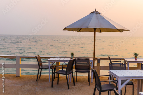 Beautiful dinner table setting on the beach at sunset
