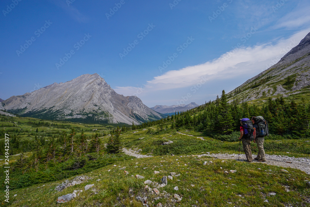 Two hikers, backpackers admiring Tombstone Mountain in Kananaskis Country, Alberta