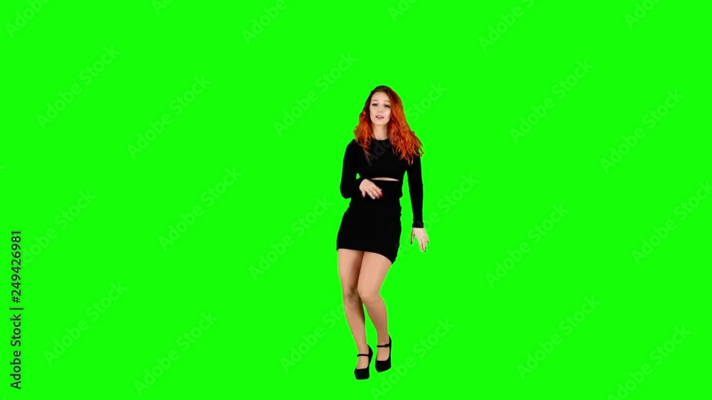 Cute Girl is Dancing and Looking into the Camera on Green Screen Cute Girl is Dancing and Looking into the Camera on Green Screen