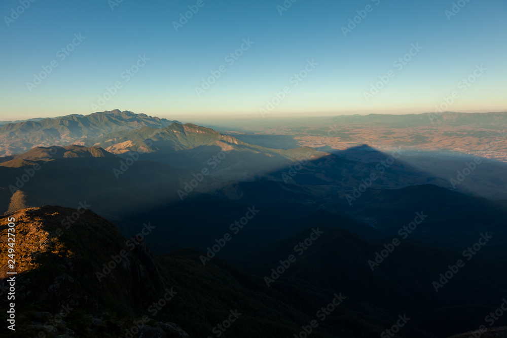 Triangular shadows of a mountain seen from the summit in mantiqueira range - Brazil Triangular shadows of a mountain seen from the summit in mantiqueira range - Brazil