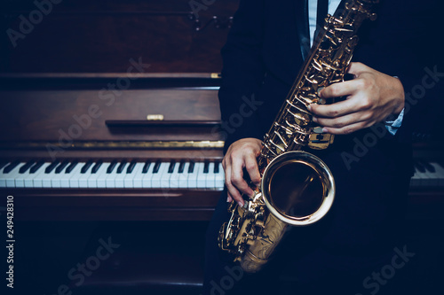 Fotografie, Obraz close up of Young Saxophone Player hands holding alto sax musical instrument wit