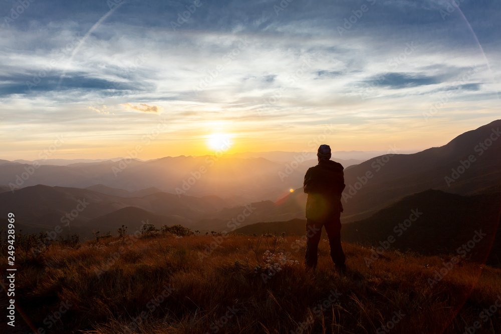 Unrecognized people enjoying the mountain landscape view from a mountain Unrecognized people enjoying the mountain landscape view from a mountain