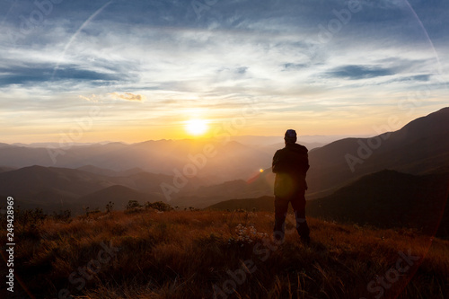 Unrecognized people enjoying the mountain landscape view from a mountain