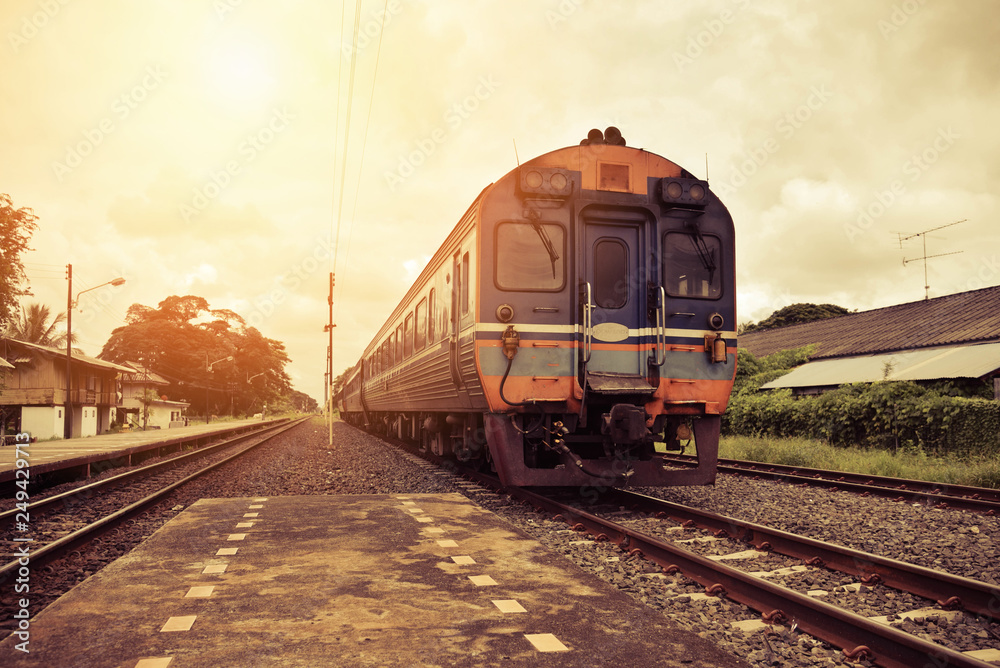 Obraz premium railroad tracks train leading from train station railway in countryside vintage old film style